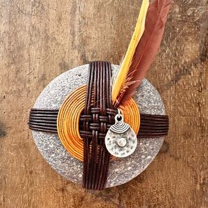 Hand wrapped Stone with Feathers and Charm